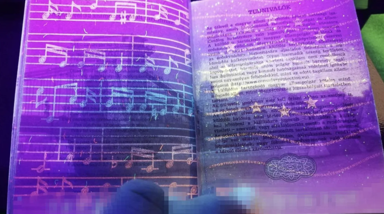 Hungary’s passport under UV light reveals a hand-drawn music score