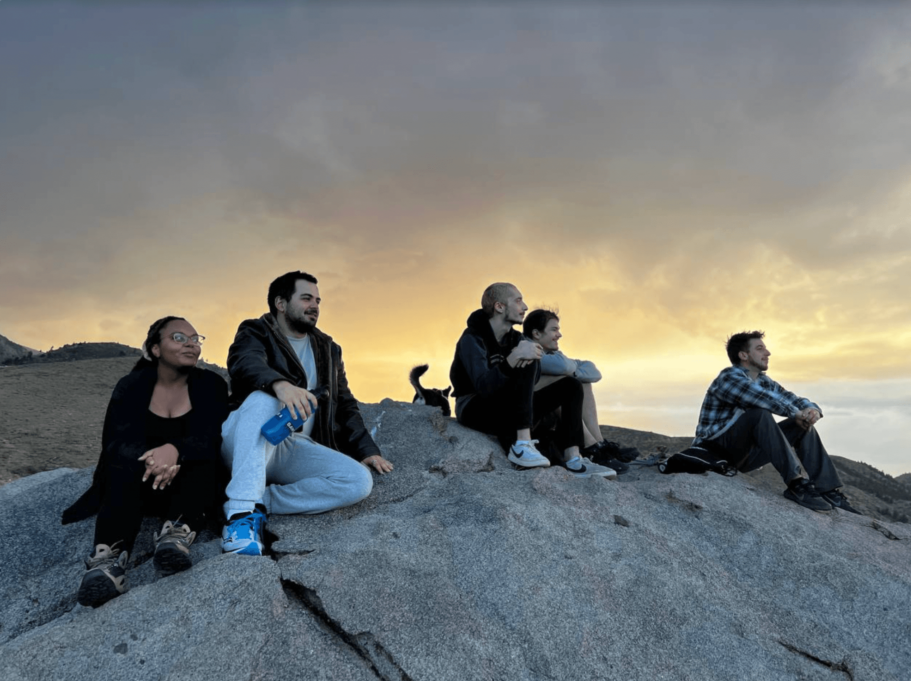 Cabin residents overlooking a sunset in the Sierra mountains