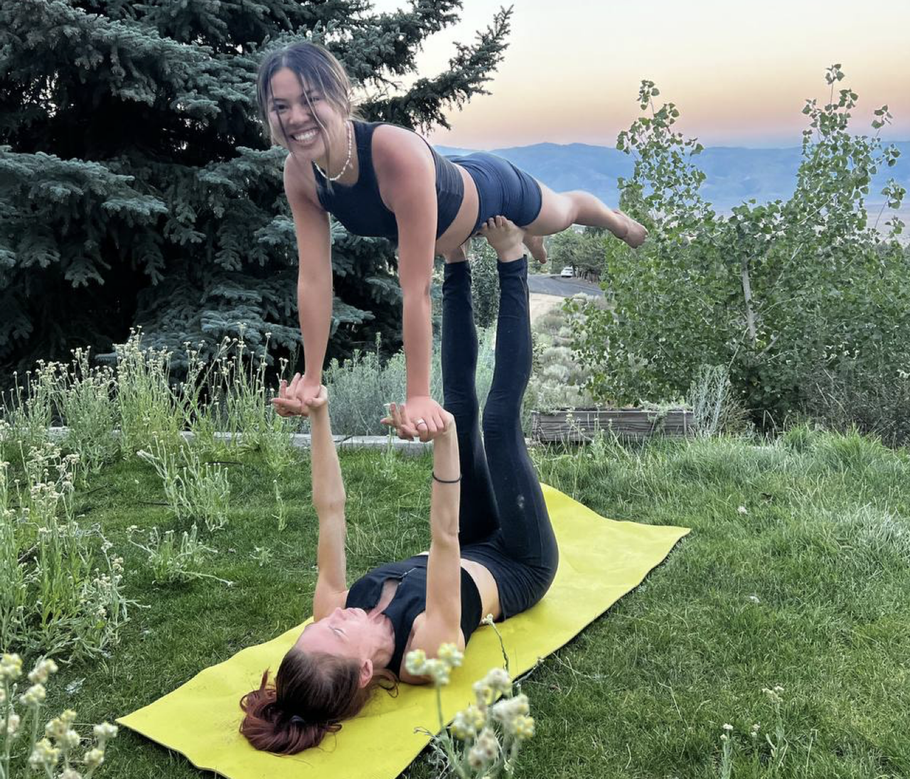 Kaela holding others up during an acroyoga session at Montaia